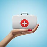 hand holding a first aid kit