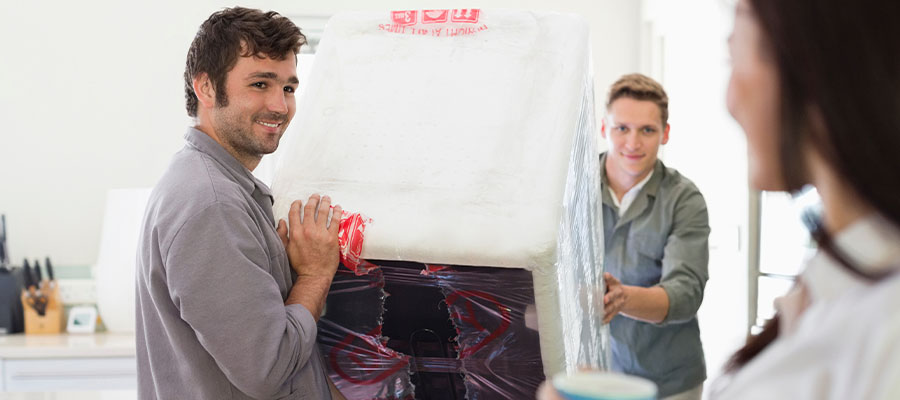 two men moving a refrigerator