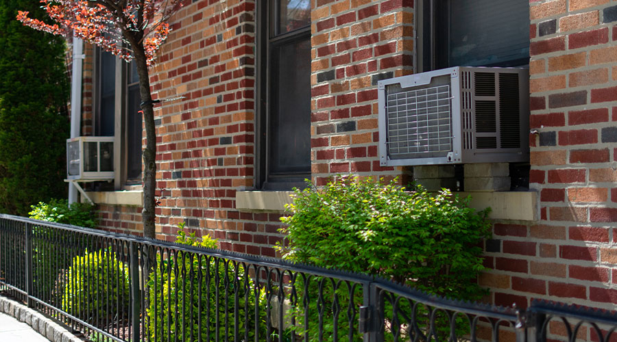 apartment building with ac units in windows